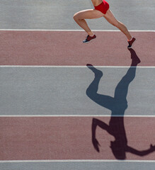 Caucasian woman runner jogger running in silhouette  on stadium background. Professional sport...