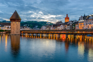 Night view towards Chapel Bridge (Kapellbruecke) together with the octagonal tall tower (Wasserturm) it is one of the Lucerne's most famous tourists attraction