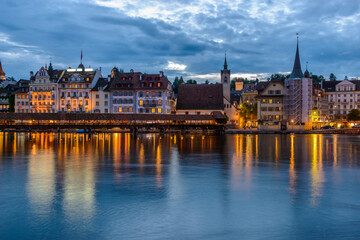 Night view towards Chapel Bridge (Kapellbruecke) together with the octagonal tall tower (Wasserturm) it is one of the Lucerne's most famous tourists attraction