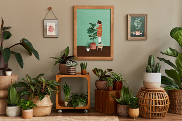 Stylish botany composition of home garden interior with wooden mock up poster frame, filled a lot...