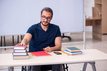 Fototapeta premium Young male handicapped student in the classroom