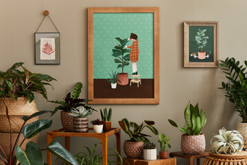 Stylish botany composition of home garden interior with wooden mock up poster frame, filled a lot...