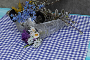  is a sugar bowl containing blue snowdrops. Nearby lies a crystal cornucopia from which the spring...