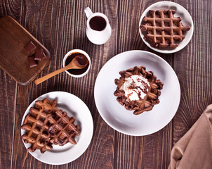 Homemade chocolate waffles with ice cream decorated chocolate syrup.