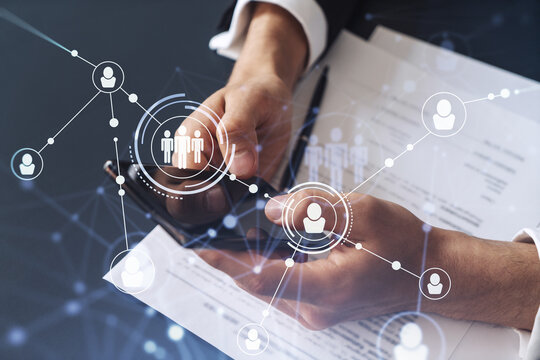 A potential employee in formal wear reading the contract to boost his career and gain new opportunities in personal growth. Checking the details of the deal at smartphone. Social media hologram icons - Powered by Adobe