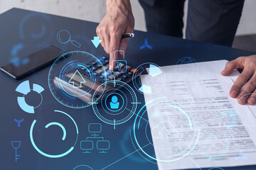 A research and development specialist computing the data to create a new approach to develop high tech business. Technological icons over the desk with calculator.