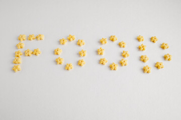 Food written on white background by honey cereal stars. 