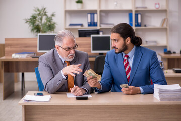 Two male employees in remuneration concept