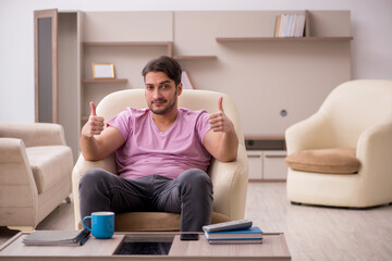 Young man siiting at home during pandemic