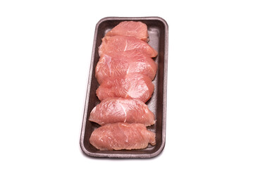 Turkey fillet in a black plastic container isolated.