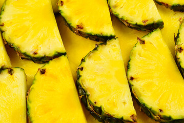 Pineapple juicy yellow slices background. Top view.