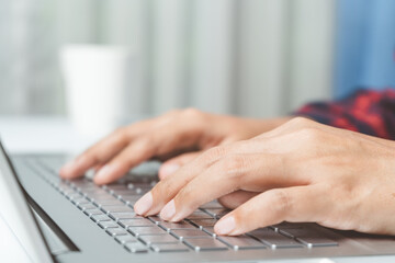 Closeup beautiful fingers woman hands typing keyboard on desk. Woman working laptop