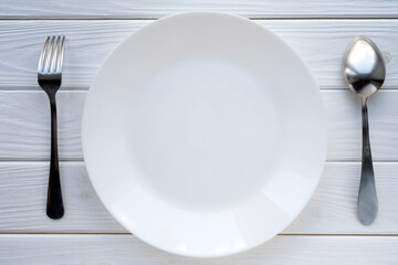 a plate with cutlery on the table