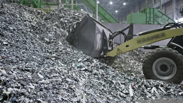 The Backhoe Loader or Excavator takes small particles of plastic with bucket