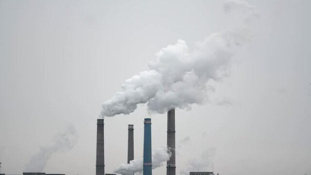 Industrial plant pipes pollute atmosphere &ndash; climate change, pollution concept