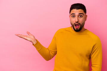 Fototapeta premium Young mixed race man isolated on pink background