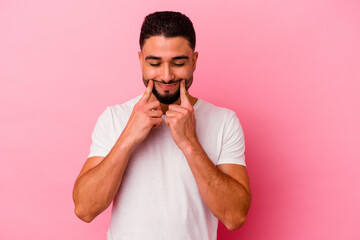 Obraz premium Young mixed race man isolated on pink background