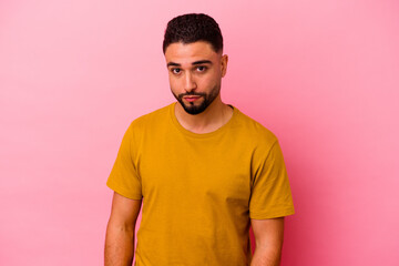 Young mixed race man isolated on pink background