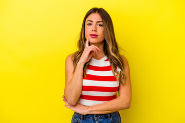 Young caucasian woman isolated on yellow background