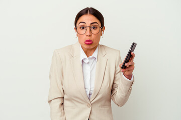 Young business woman holding a mobile phone isolated on white background