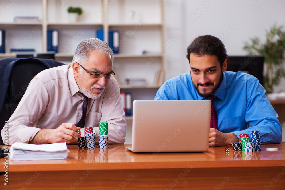 Canvas Prints two male employees playing cards at workplace