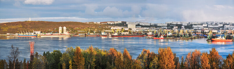 Fototapeta na wymiar Golden autumn. View of the city of Murmansk and the port (panorama) Murmansk seaport is the only non-freezing Northern port of Russia, and only because the Gulf Stream enters the Kola Bay (Barents Sea