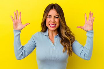Young caucasian woman isolated on yellow background