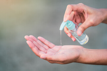 New normal lifestyle: Pouring alcohol gel on hands to sanitize covid-19 virus.