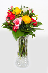 Bouquet of colorful flowers in a glass vase. 