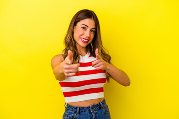 Young caucasian woman isolated on yellow background