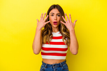 Young caucasian woman isolated on yellow background