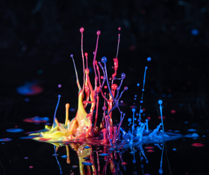 Abstract splash of color ink on black background