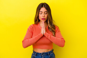 Young caucasian woman isolated on yellow background