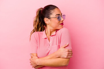 Young caucasian woman isolated on pink background