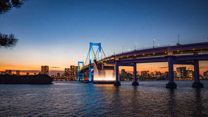 Cityscape view of Tokyo Bay , Rainbow bridge and Tokyo Tower at Sunset