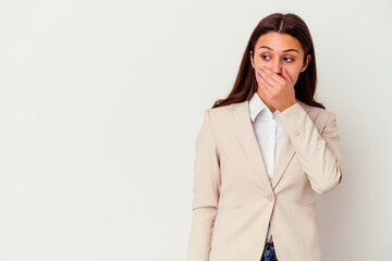 Young Indian business woman isolated on white background thoughtful looking to a copy space covering mouth with hand.