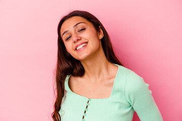 Fototapeta premium Young Indian woman isolated on pink background confident keeping hands on hips.