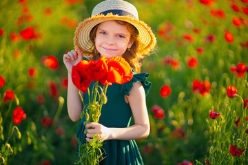 beautiful girl in poppy field enjoys the beauty and aromas.