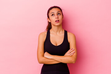 Young sport Indian woman isolated on pink background tired of a repetitive task.