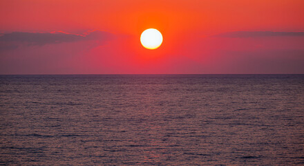 Amazing red sunset with yellow sun over the sea - Side, Turkey