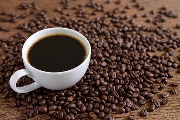 Black coffee and coffee beans roasted on wooden background,copy space.