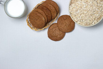 A glass of milk and oatmeal cookies on a white background. Diet food. Light breakfast