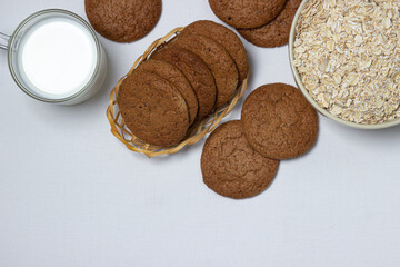 A glass of milk and oatmeal cookies on a white background. Diet food. Light breakfast
