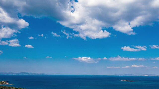 Blue sea and sky background, blue shades and white clouds, aerial drone footage of the bay, video 4k