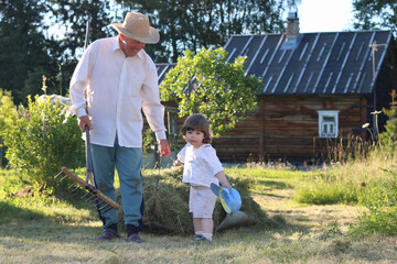 child and grandfather harvested hay