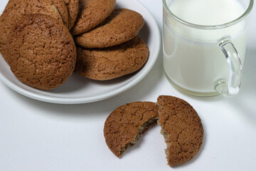 A glass of milk and oatmeal cookies on a white background. Diet food. Light breakfast