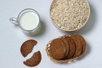 A glass of milk and oatmeal cookies on a white background. Diet food. Light breakfast