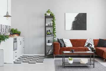Scandinavian style in spacious living room with comfortable brown corner sofa
