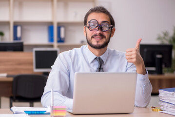 Young funny businessman employee working at workplace