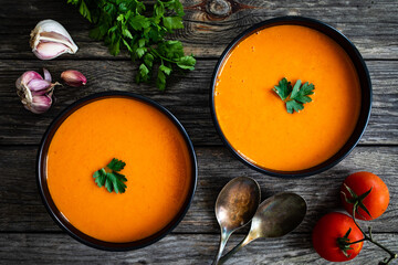 Cream tomato soup on wooden table
